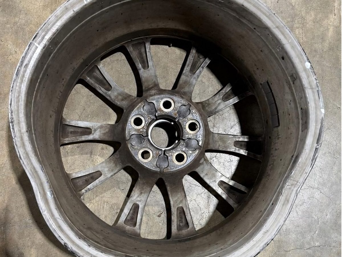 Bent and damaged alloy wheel rim before straightening repair in North Little Rock Arkansas