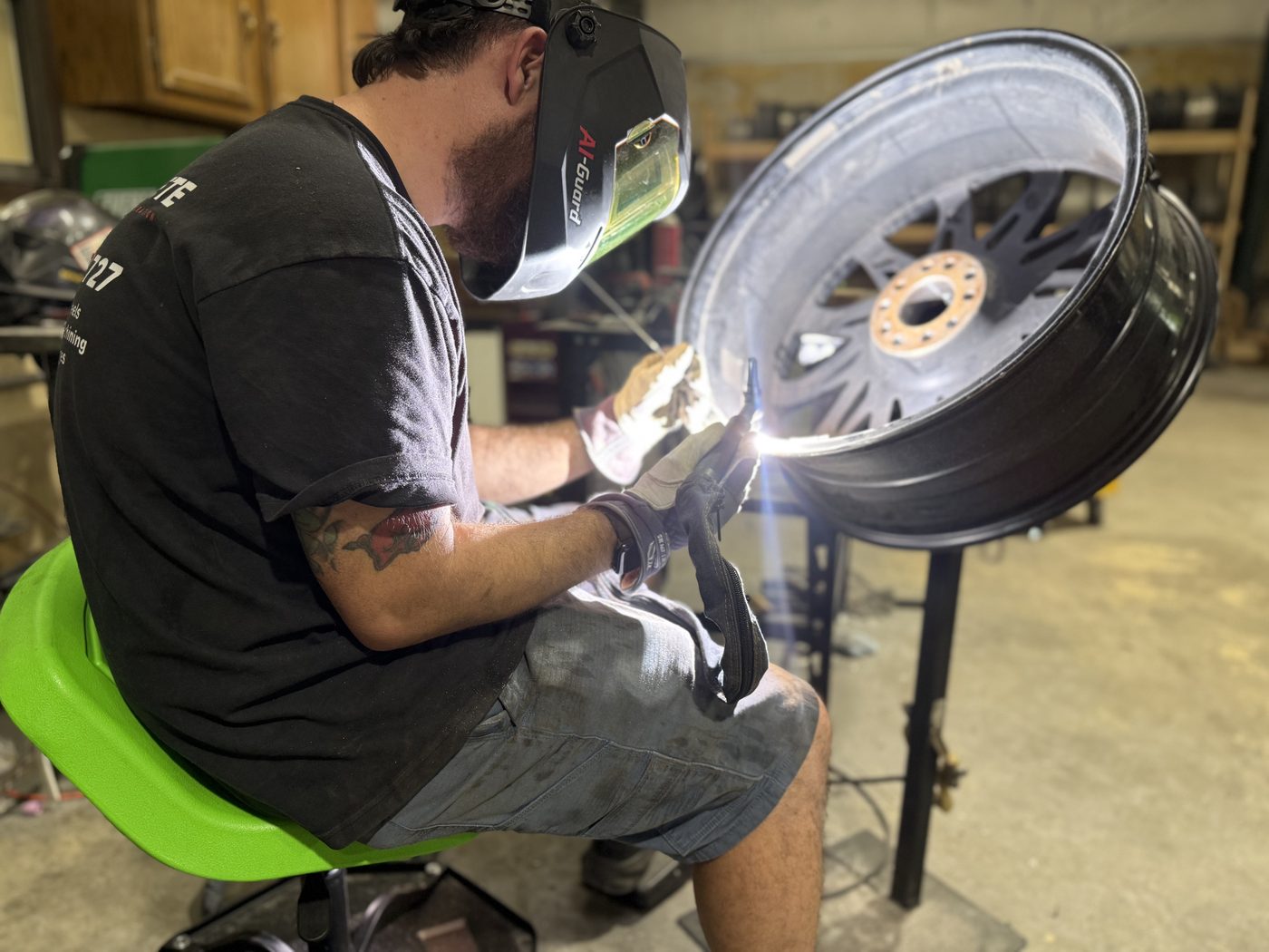 Technician welding a cracked aluminum wheel with full-penetration technique in Arkansas