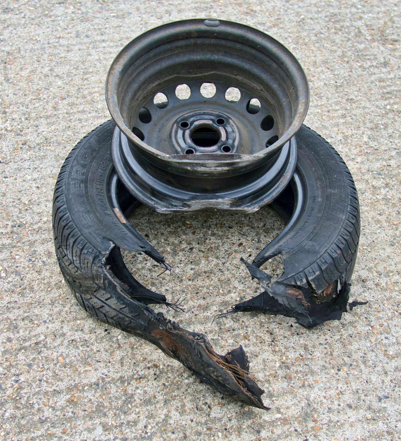 Damaged alloy wheel with curb rash and poor spray paint repair in Arkansas